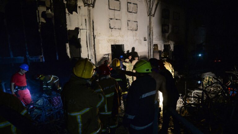 Civil defense members inspect the scene of a fire that broke out during a wedding at an event hall in Al-Hamdaniyah, Iraq on September 27, 2023.