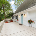 Single family home in Malden with white siding, and light blue door.
