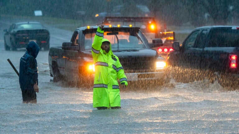 Vehicles make their way through a flooded Lancaster Street during heavy rain in Leominster, Mass., Monday, Sept. 11, 2023.