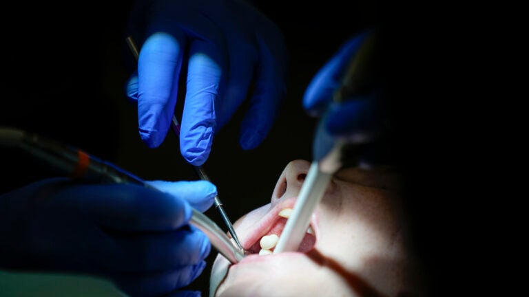 Danielle Wilkes is seen by a dentist during a clinic visit.