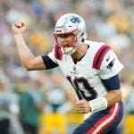GREEN BAY, WISCONSIN - AUGUST 19: Mac Jones #10 of the New England Patriots celebrates after a touchdown in the first quarter against the Green Bay Packers during a preseason game at Lambeau Field on August 19, 2023 in Green Bay, Wisconsin.