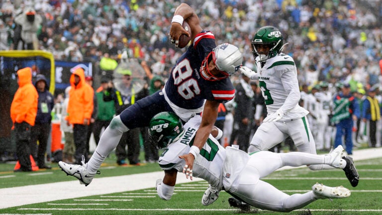 New England Patriots tight end Pharaoh Brown (86) pushes for the end zone against New York Jets safety Adrian Amos (0) to score a touchdown during the second quarter of an NFL football game, Sunday, Sept. 24, 2023, in East Rutherford, N.J.