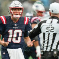 New England Patriots quarterback Mac Jones (10) speaks with the referee during the second half an NFL football game against the New York Jets on Sunday Sept. 24, 2023, in New York.