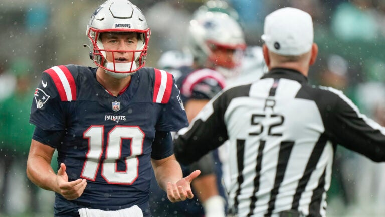 New England Patriots quarterback Mac Jones (10) speaks with the referee during the second half an NFL football game against the New York Jets on Sunday Sept. 24, 2023, in New York.