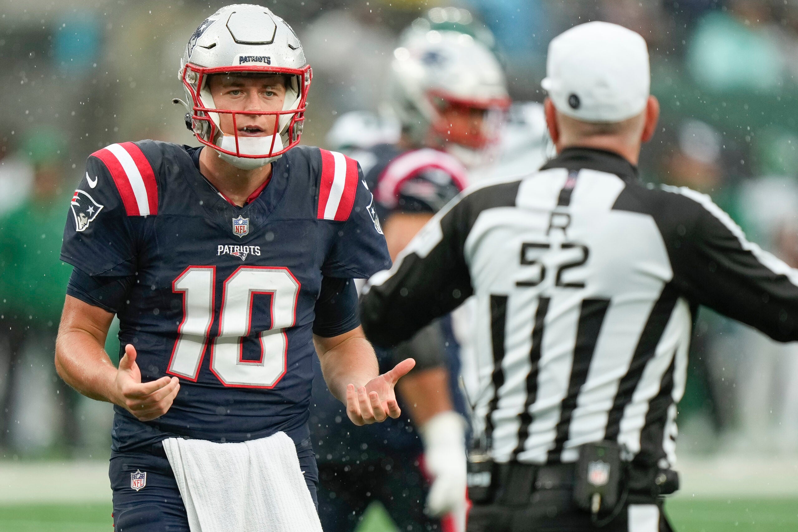 New England Patriots quarterback Mac Jones (10) speaks with the referee during the second half an NFL football game against the New York Jets on Sunday Sept. 24, 2023, in New York.