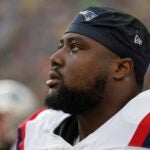 New England Patriots defensive tackle Christian Barmore (90) participates in warmups during a preseason NFL football game between the New England Patriots and Green Bay Packers Saturday, Aug. 19, 2023, in Green Bay, Wis.