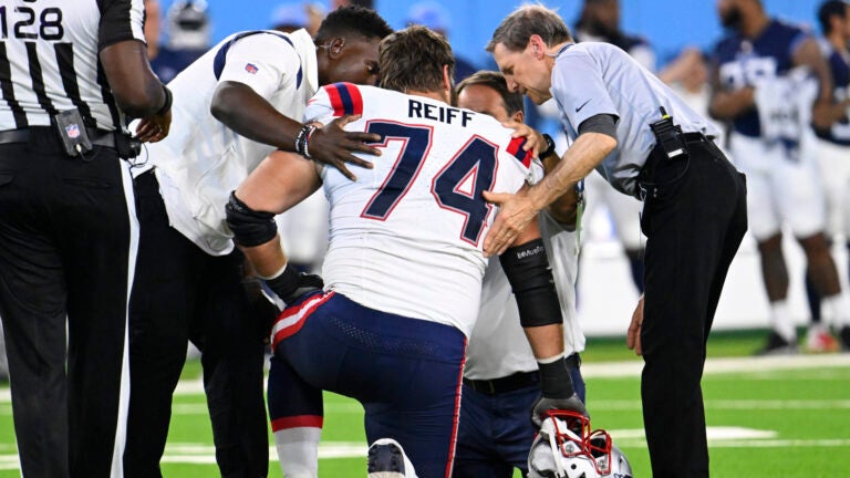 New England Patriots offensive tackle Riley Reiff (74) is tended to after being hurt during an NFL preseason football game against the Tennessee Titans Saturday, Aug. 26, 2023, in Nashville, Tenn.