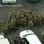 Law enforcement officers pose for a group photo with Danelo Cavalcante.