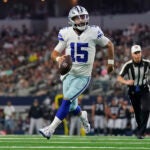 Dallas Cowboys quarterback Will Grier runs with the ball during the first half of a preseason NFL football game against the Las Vegas Raiders in Arlington, Texas, Saturday, Aug. 26, 2023.