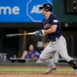 Rob Refsnyder of the Red Sox follows through on a two-run single in the eighth inning.