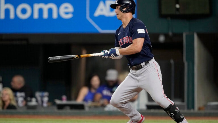 Rob Refsnyder of the Red Sox follows through on a two-run single in the eighth inning.