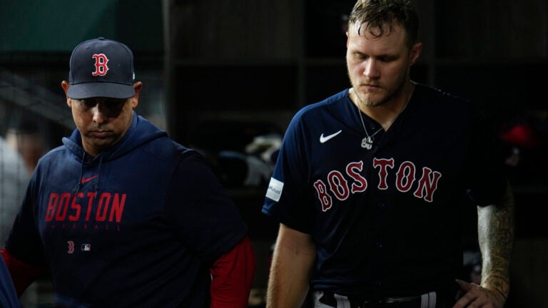 Red Sox starting pitcher Tanner Houck, right, stands in the dugout with manager Alex Cora after being pulled from the mound for a reliever during the fifth inning.