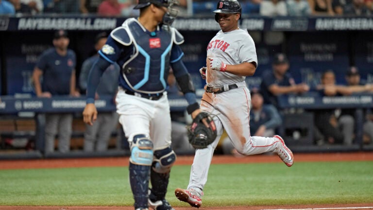 Rafael Devers of the Red Sox scores behind Rays catcher Christian Bethancourt during the fourth inning.