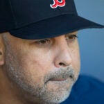 Boston Red Sox manager Alex Cora talks to the media.