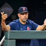 Boston Red Sox manager Alex Cora gestures to the home plate umpire during the sixth inning of a baseball game against the Kansas City Royals, Saturday, Sept. 2, 2023, in Kansas City, Mo.