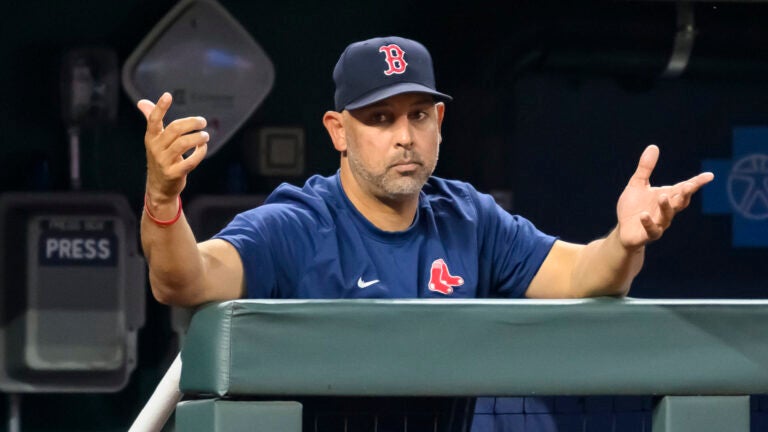 Boston Red Sox manager Alex Cora gestures to the home plate umpire during the sixth inning of a baseball game against the Kansas City Royals, Saturday, Sept. 2, 2023, in Kansas City, Mo.