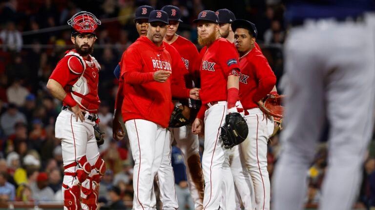 Justin Turner of the Boston Red Sox talks with manger Alex Cora