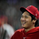 Los Angeles Angels' Shohei Ohtani laughs in the dugout.