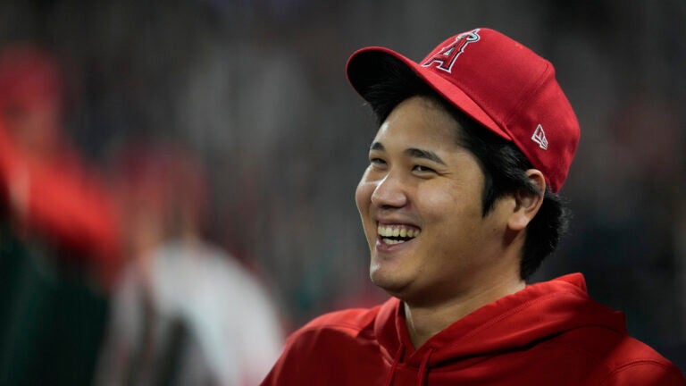 Los Angeles Angels' Shohei Ohtani laughs in the dugout.