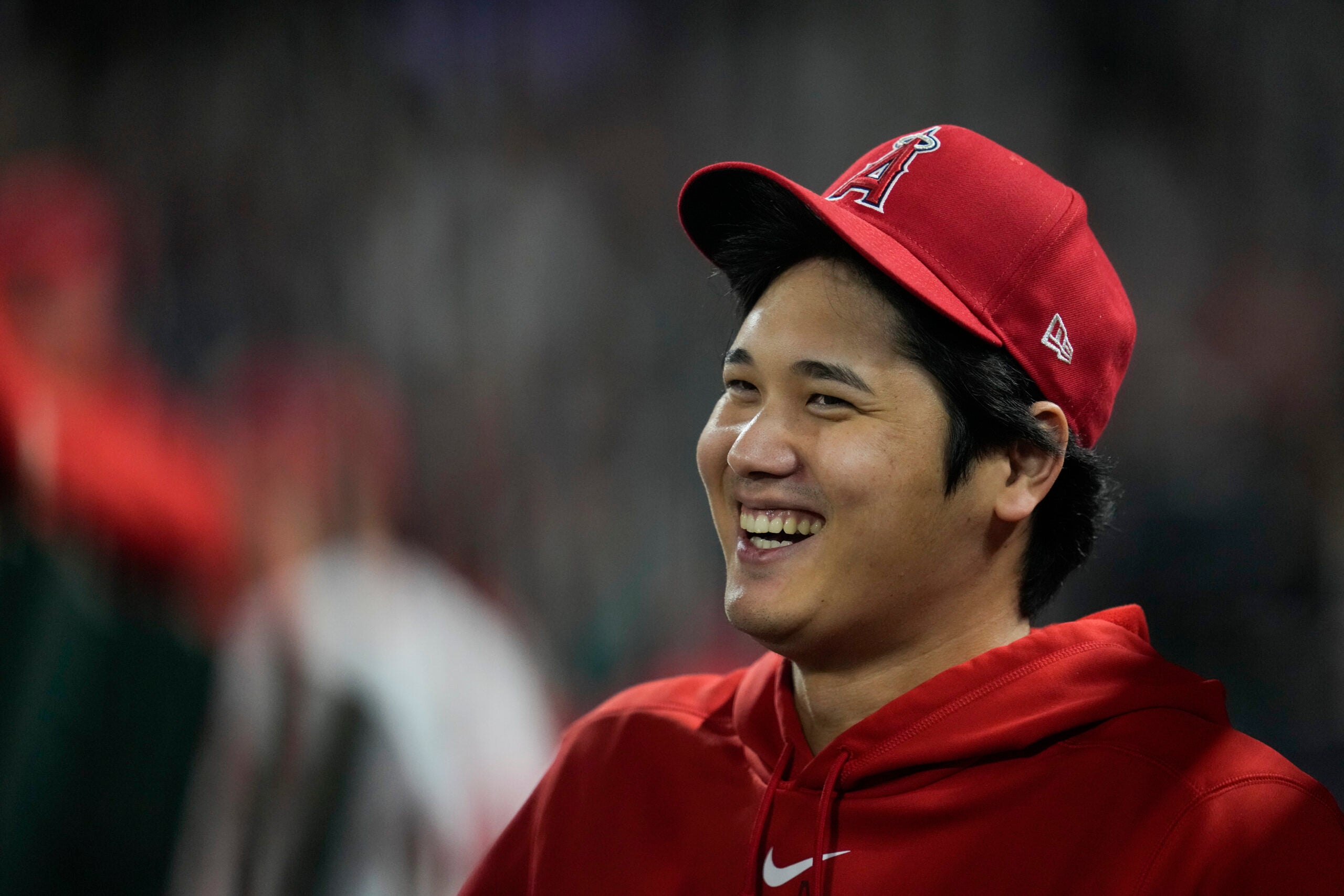 Los Angeles Angels' Shohei Ohtani laughs in the dugout.