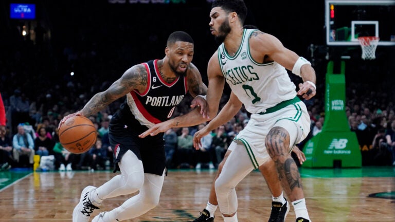 Damian Lillard drives to the basket against Jayson Tatum during a March 8, 2023 game in Boston.