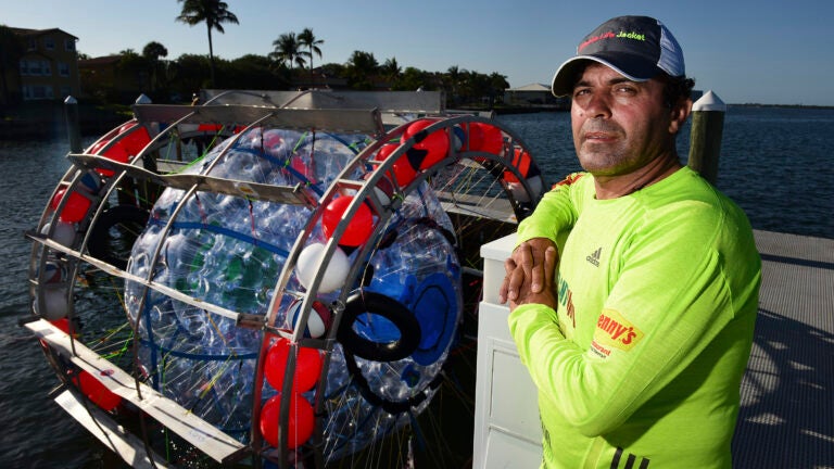 Reza Baluchi in Lake Park, Fla. with his buoyant human-size hamster wheel.