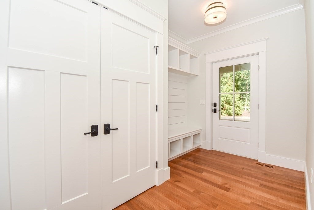 Entryway in Weston home with white wood cabinets. 