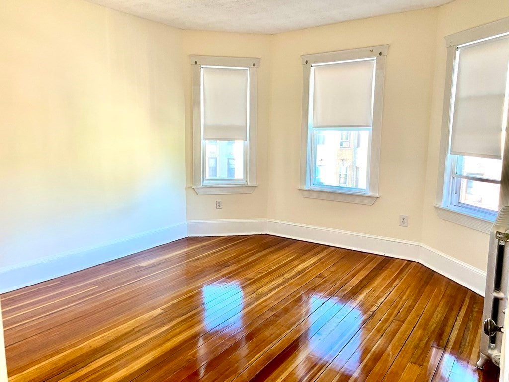 Empty room with wood flooring. 