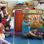 Jameson Pilling (cq), 3, claps with teacher Kerrelle Dow (cq). Little Discoveries provides child care in Brockton. A classroom with 3- to 5-year-olds is photographed, on Thursday, May 21, 2015.