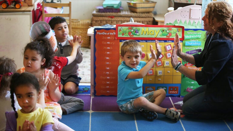 Jameson Pilling (cq), 3, claps with teacher Kerrelle Dow (cq). Little Discoveries provides child care in Brockton. A classroom with 3- to 5-year-olds is photographed, on Thursday, May 21, 2015.