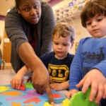 Teacher Latonya Hazard works on puzzles with students (left to right) Lilyana Waire, 2, Jordan Conrad, 2, Caiden Groccia, 2, and Joshua Davis, 2, at the Guild of St. Agnes in Worcester, MA on April 25, 2017.