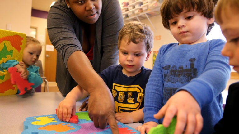 Teacher Latonya Hazard works on puzzles with students (left to right) Lilyana Waire, 2, Jordan Conrad, 2, Caiden Groccia, 2, and Joshua Davis, 2, at the Guild of St. Agnes in Worcester, MA on April 25, 2017.