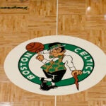 The Boston Celtics logo and Red Auerbach signature are seen on the TD Garden parquet floor before the start of an NBA basketball game, Wednesday, Feb. 27, 2019, in Boston.