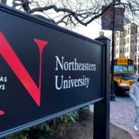 A picture of a black Northeastern University campus sign.