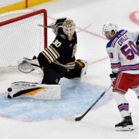 Boston Bruins’ goalie Brandon Bussi blocks a goal attempt by New York Rangers’ Will Cuylle (50) during the third period of an NHL exhibition game at TD Garden in Boston, Sunday, Sept. 24, 2023.