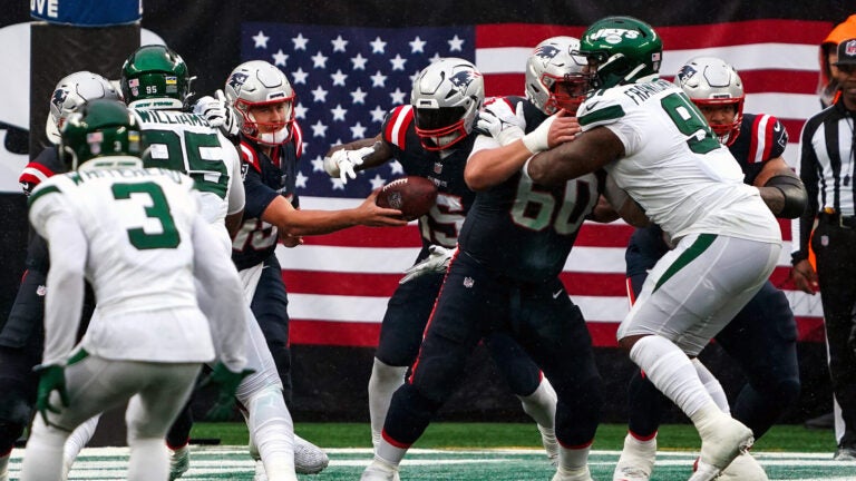 New England Patriots quarterback Mac Jones (10) hands off to New England Patriots running back Ezekiel Elliott (15) with better line blocking for the run during the third quarter. The New York Jets host the New England Patriots at MetLife Stadium in East Rutherford, NJ Sunday, September 24, 2023.