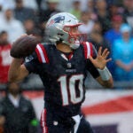 New England Patriots quarterback Mac Jones (10) throws a pass in the rain against the Philadelphia Eagles during first quarter NFL action at Gillette Stadium in Foxborough. 