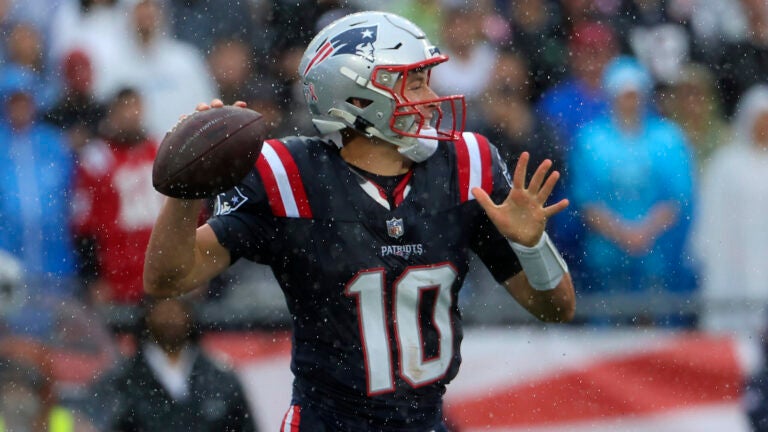 New England Patriots quarterback Mac Jones (10) throws a pass in the rain against the Philadelphia Eagles during first quarter NFL action at Gillette Stadium in Foxborough. 