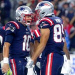 New England Patriots quarterback Mac Jones celebrates his touchdown reception with Hunter Henry against the Tampa Bay Bucs during fourth quarter NFL action at Gillette Stadium.
