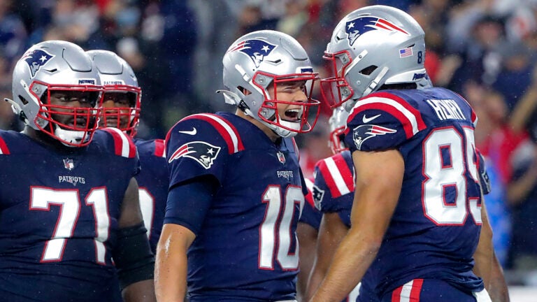 New England Patriots quarterback Mac Jones celebrates his touchdown reception with Hunter Henry against the Tampa Bay Bucs during fourth quarter NFL action at Gillette Stadium.