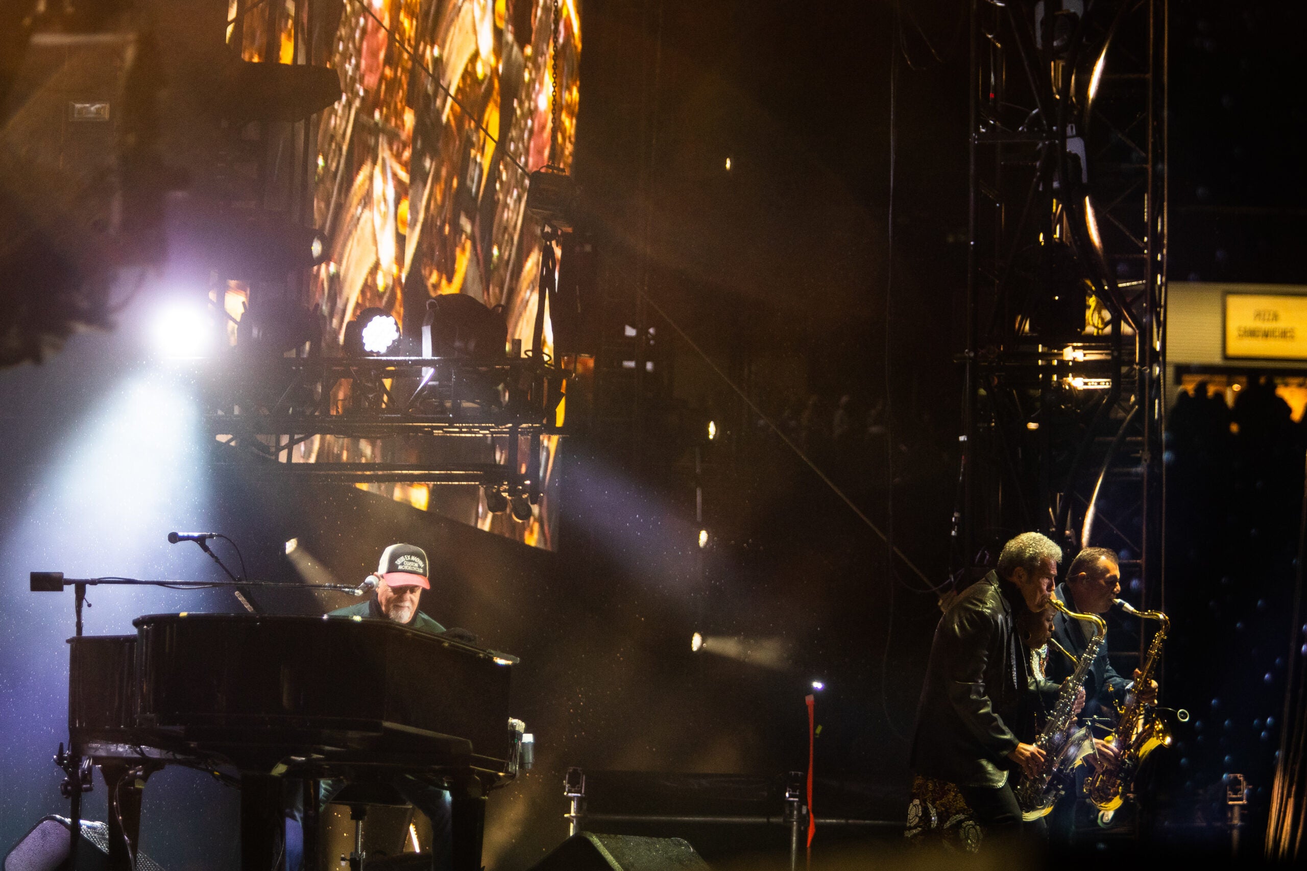 Billy Joel, left, performs with members of his band at Gillette Stadium. (
