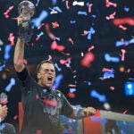 As confetti falls around him, Patriots quartetrback Tom Brady howls as he hoists the Vince Lombardi Trophy following New England's come from behind victory. The Atlanta Falcons play the New England Patriots in Super Bowl LI at NRG Stadium in Houston on Feb 5.