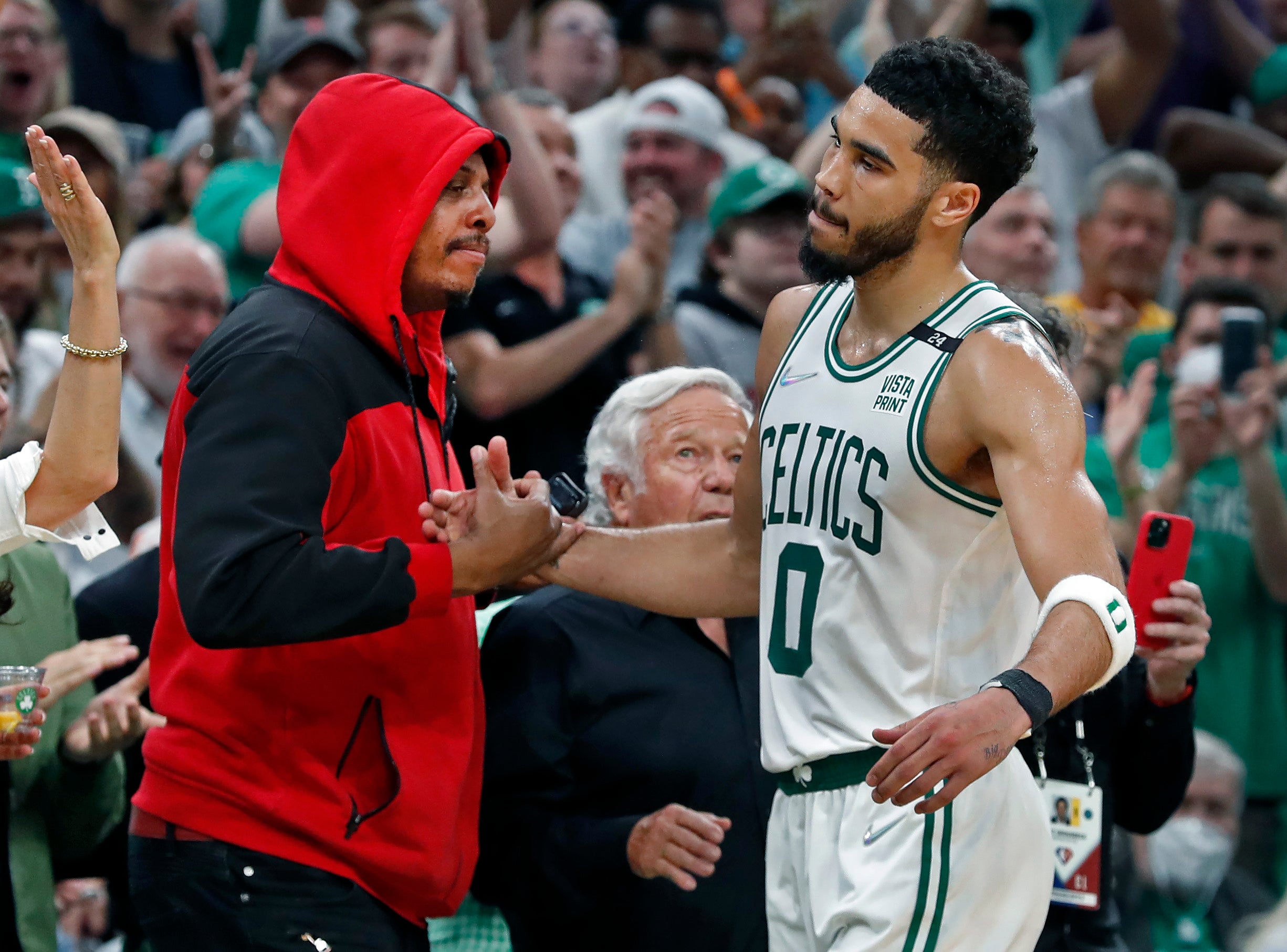 The Celtics Jayson Tatum gets a hand from NBA Hall of Famer Paul Pierce as he leaves the game. New England Patriots owner Robert Kraft is in between them. The Boston Celtics hosted the Milwaukee Bucks for Game Seven of their NBA basketball Eastern Conference Semi-Final Playoff series at the TD Garden.
