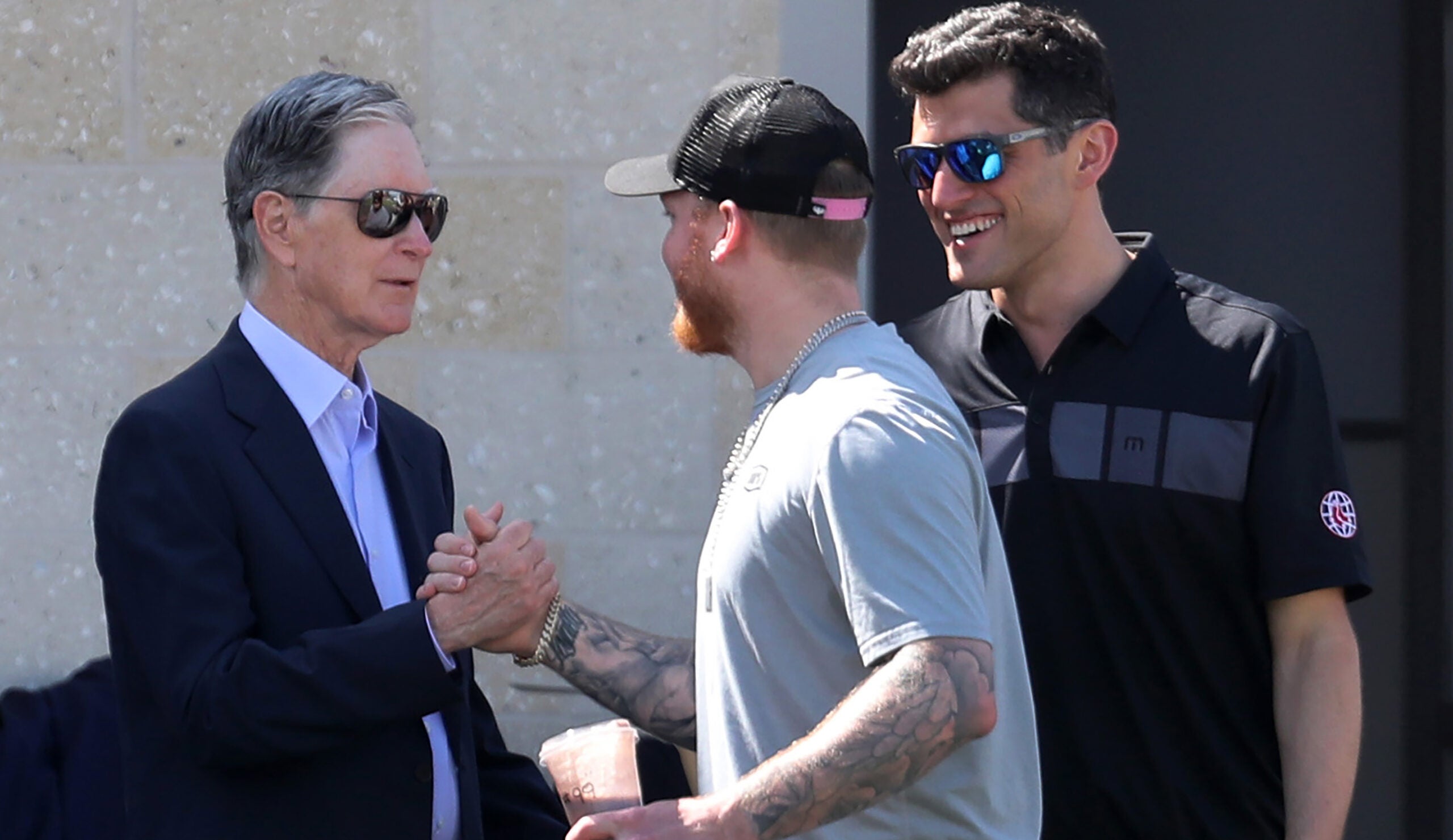 Red Sox principal owner John Henry (left) and now former chief baseball officer Chaim Bloom greet Alex Verdugo during Spring Training.