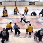 Bruins captain Brad Marchand takes to the center of the spoked-B at the end of practice as he talks to the players. The Boston Bruins held their first day of practice their training camp at the Warrior Ice Arena.
