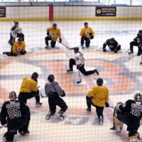 Bruins captain Brad Marchand takes to the center of the spoked-B at the end of practice as he talks to the players. The Boston Bruins held their first day of practice their training camp at the Warrior Ice Arena.