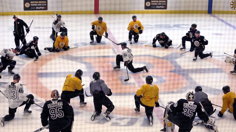 Bruins captain Brad Marchand takes to the center of the spoked-B at the end of practice as he talks to the players. The Boston Bruins held their first day of practice their training camp at the Warrior Ice Arena.