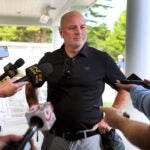 The Boston Bruins held their annual charity golf tournament at the Pinehills Golf Course. Coach Jim Montgomery chats with reporters.