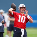 Matt Patricia(left) keeps an eye on qb Mac Jones firing a pass as the New England Patriots held their 2nd day of training camp on the practice fields behind Gillette Stadium on Thursday morning.