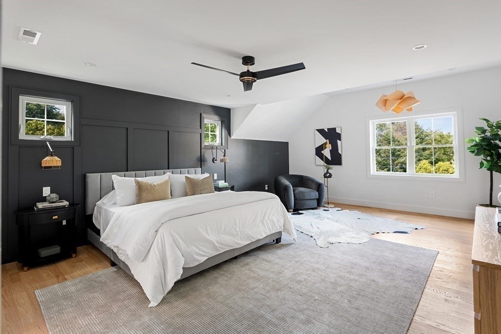 Bedroom with a black accent wall in Woburn home. 